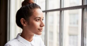 A woman thinking about when she should take a pregnancy test