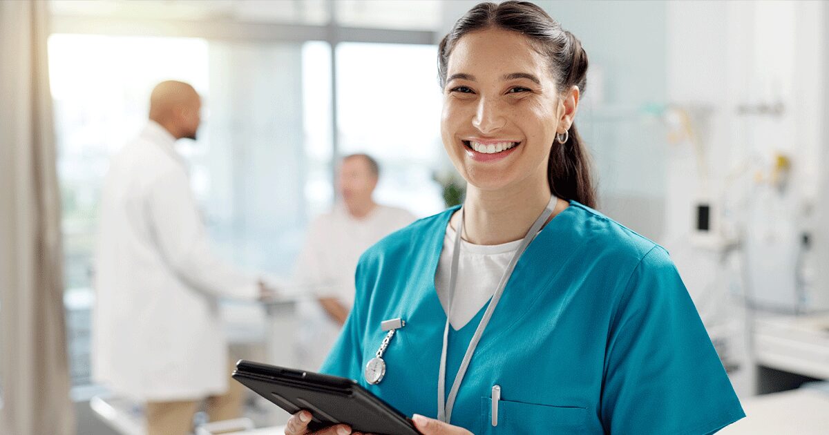 Smiling nurse holding a tablet in a medical clinic, ready to answer questions about abortion pills and pregnancy options.
